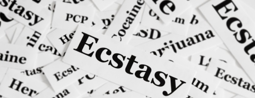 Papierschnipsel mit Drogennamen beschriftet, Ecstasy im Vordergrund